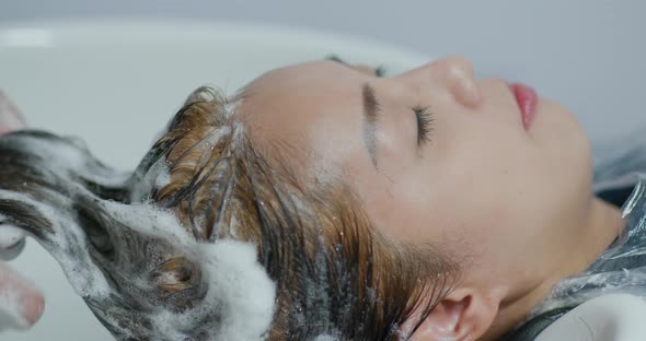 Woman wash her hair in salon