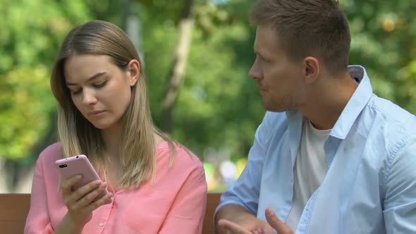Offended Woman With Cellphone Ignoring Boyfriends Reconciliation Efforts, Crisis