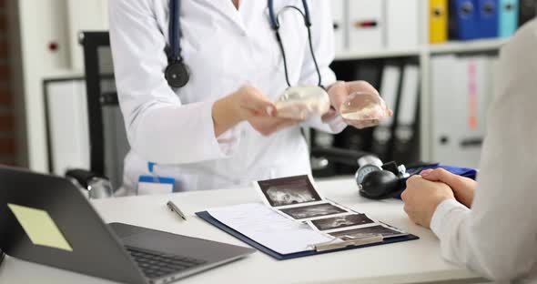 Plastic Surgeon Shows Silicone Breast Implant to Woman