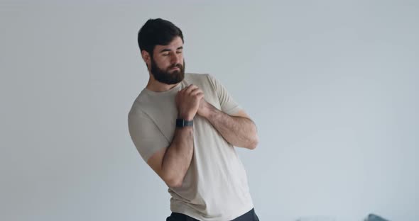 Sporty Millennial Guy Training at Home, Warming Up