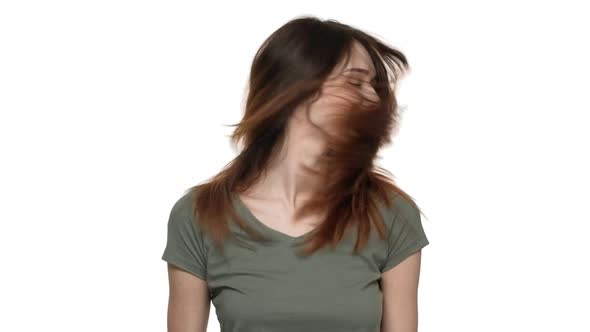 Portrait of Joyful Woman 20s Playing Around and Shaking Her Auburn Hair Isolated Over White