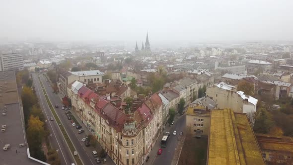 Aerial view of the corner house on the background of the Church of Olha and Elizabeth