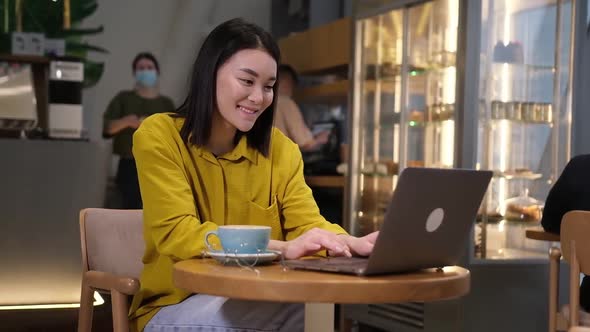 Business Entrepreneur Asian Girl Working Online on Laptop in Cafe