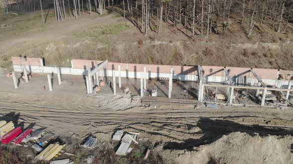 Flight Near the Unfinished Monolithic house.Builders Are Building a House.