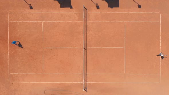 Professional Tennis Players Playing on Red Clay Court. Aerial Top Down Drone View