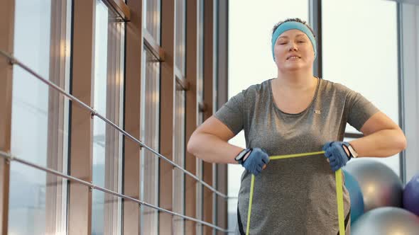 Woman with Excess Weight Workout Tirelessly at a Gym
