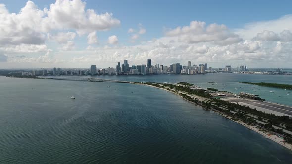 Aerial pulling away from the downtown Miami skyline near Key Biscayne