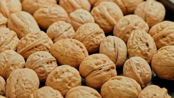 Looped Spinning Walnuts with Shells Closeup Full Frame Background