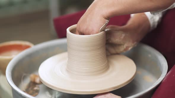 Production of Handmade Tableware the Potter Makes a Pitcher Out of Clay Closeup View of the Hands