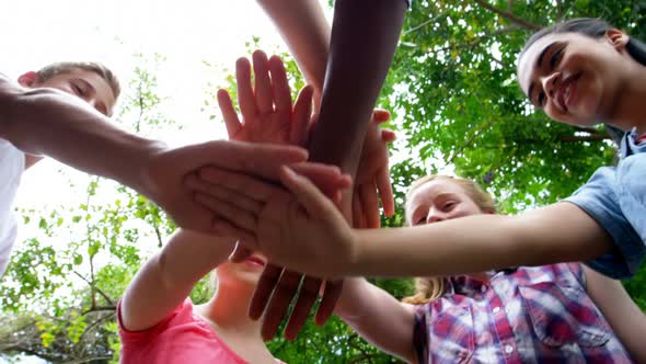 Schoolkids forming hand stack in school premises 4k