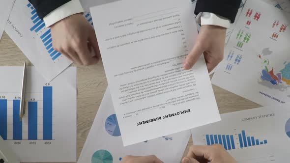 Male in Suit Signing Employment Agreement and Giving It to Manager, Business