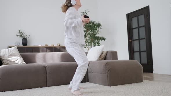 Young Woman Listening To Music And Dancing In Headphones