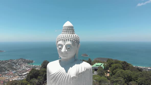 Majestic Big Buddha sitting atop Nakkerd Hill looking after Chalong in Phuket, Thailand 