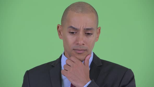 Face of Stressed Bald Multi Ethnic Businessman Thinking and Looking Down