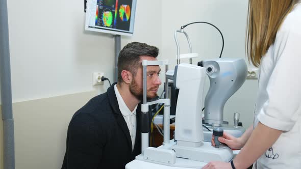 Male patient in ophthalmology clinic. Selective focus on man`s face while checking vision.