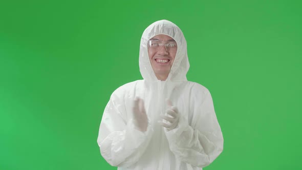 Man Wearing Protective Equipment Uniform Ppe And Clapping His Hands In The Green Screen Studio