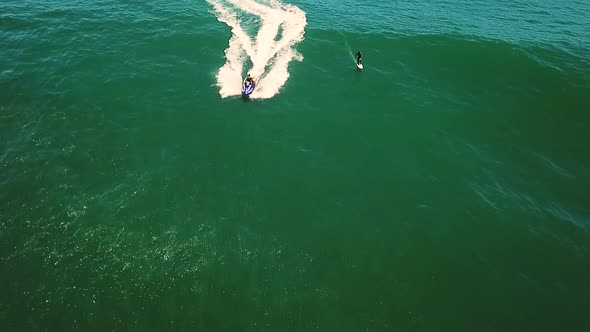 Aerial view of a surfer being towed with a jet ski near Cape Town, South Africa.