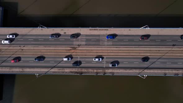 Moving Cars on Bridge Over River in European City Aerial View