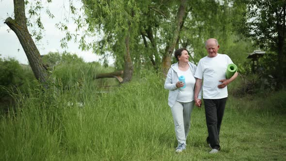 Healthy Old People Male and Female Married Couple Take Care of Their Health Go Holding Hands After