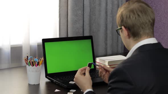Man Teacher Making Online Video Call on Laptop. Green Screen. Distance Education