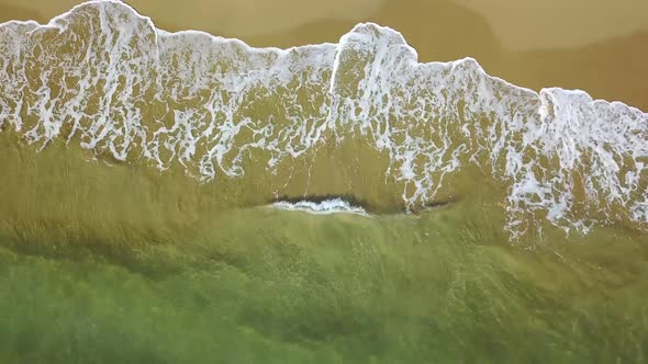 Turquoise Surf of the Sea Waves on Yellow Sand. Aerial Survey