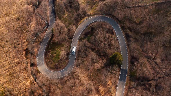 Cinematic Drone Shot of Camper Van on Scenic Road