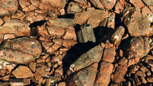 Old Rusty Metal Canister for Gasoline Fuel at Rocks