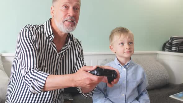 Emotional Grandfather Plays with His Grandson in Computer Games with a Joystick