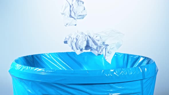 Super Slow Motion Shot of Crumpled Papers Falling Into Trash Can at 1000Fps