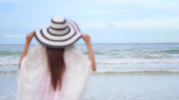 Asian woman enjoy around beautiful beach sea ocean