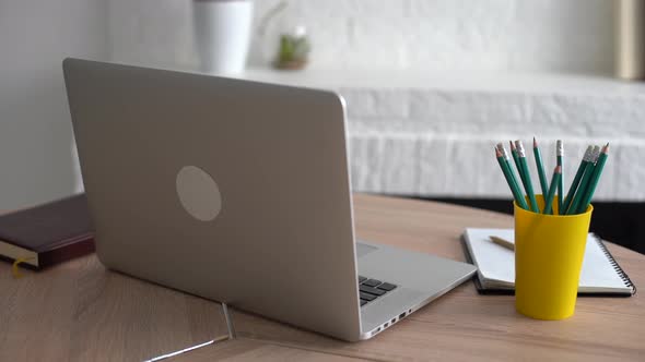 Office Workplace with Notebook on Wood Table