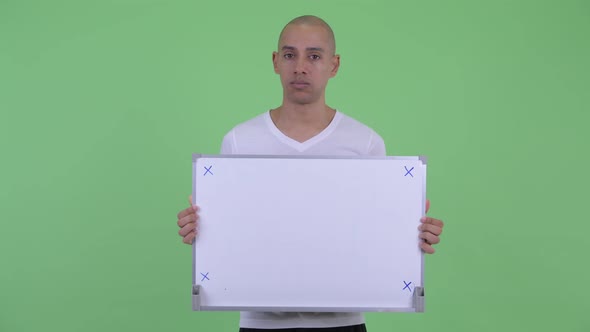 Stressed Bald Man Holding White Board and Getting Bad News