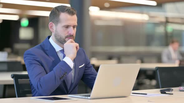 Pensive Businessman Thinking At Work