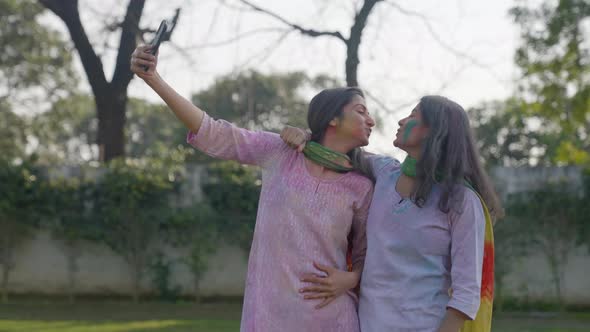Indian girls taking selfies at a Holi party