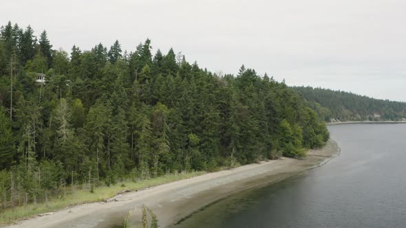 Washington State Coast Aerial View Of Island Forest Above Beach In Port Townsend