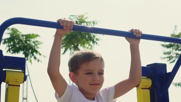 A Little Boy Does Sports on the Playground