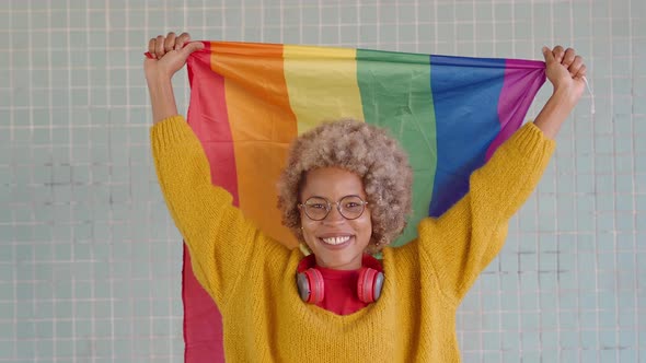 Cheerful African American Woman with Afro Hair and a Lgtb Flag