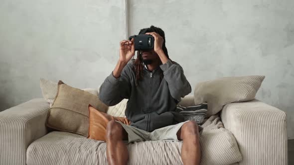 Handsome African Hipster Putting on VR Headset