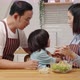 Asian boy who dislikes vegetables, is being asked by his parents to eat vegetables for his health. - VideoHive Item for Sale