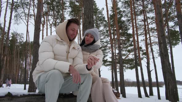 Family Couple Resting in the Winter in the Forest