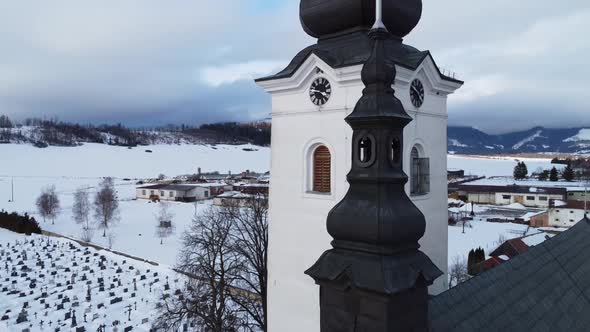 Aerial shot of church, during winter, near village.