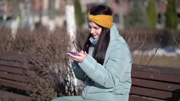 Young Woman Texting on the Smartphone