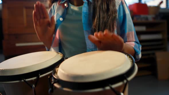 Schoolgirl playing drum in music class 4k