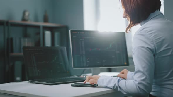 Woman Using Computers for Working with Stock Market