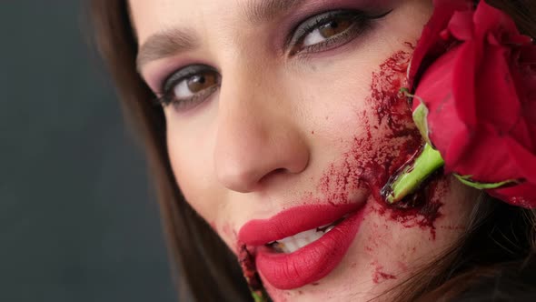 Beautiful Girl with a Beautiful Art Makeup on Her Face She Has a Rose Flower in Her Mouth