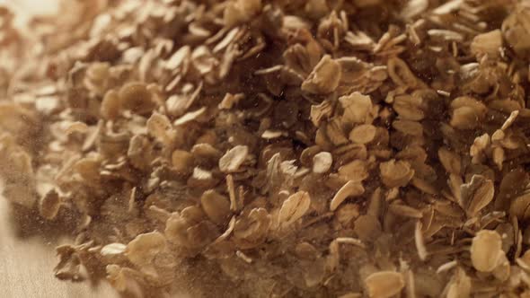 Oatmeal falling on a table. Slow Motion.