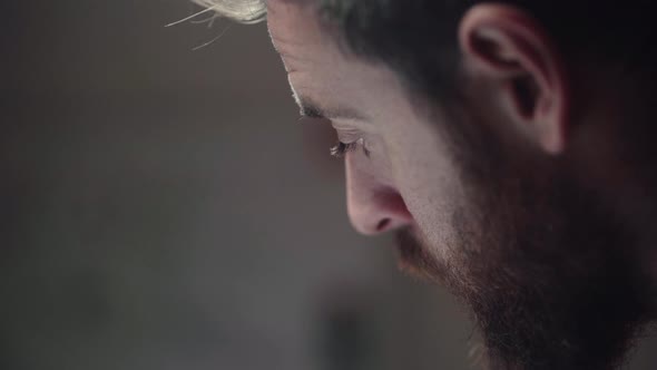 A Bearded Man Pondering Thoughts While Studying - close up, selective focus