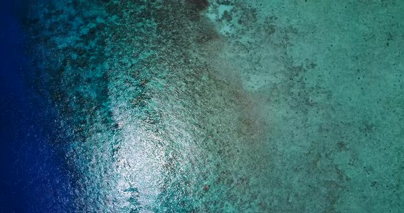 Tropical overhead island view of a paradise sunny white sand beach and aqua turquoise water backgrou