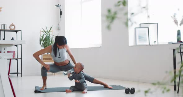 Mom and Child Do Fitness at Home During Isolation