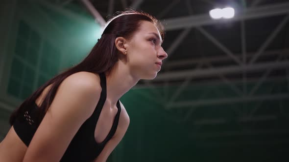 Young Brunette Sportswoman is Playing Tennis Waiting Serve of Opponent on Tennis Court Standing in